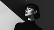 © Anastasiia K. - woman in black clothes on a monochrome background. Black and white photo - Portrait of a beautiful young woman dressed in all black on a minimalistic background