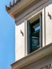 Wall Mural - A classic design window with green shutters under the deep blue sky. Travel to Athens, Greece.