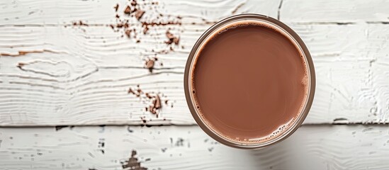 Sticker - Fresh chocolate milk presented in a bottom glass on a white wood backdrop with a banner for copy space image.