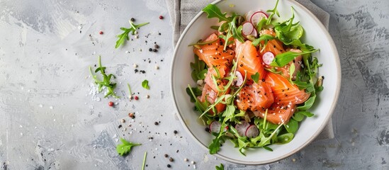 Poster - A bowl of classic Russian Olivie salad with smoked salmon on a light gray backdrop, perfect for a copy space image.