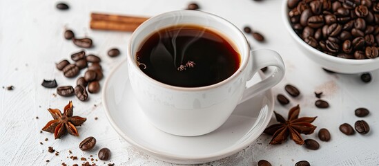 Aufkleber - A white cup filled with black aromatic coffee rests on a light table surrounded by roasted beans and an anise star, providing copy space in the image.