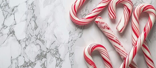 Aufkleber - Candy canes displayed with a marble backdrop, providing an elegant frame for the confectionery in a visually appealing copy space image.