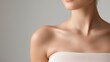 © Stone Story - Close-up of a woman's shoulder and collarbone area, highlighting smooth, radiant skin in a soft, neutral background.