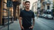 © NickArt - Young handsome model looking man close up photo in black mockup t-shirt walking at camera on daylight city street