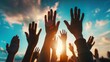 © Lull - Hands raised in unity at sunset. Crowd with hands raised in the air at a sunset, symbolizing unity, hope, and celebration.