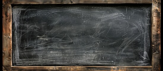 Poster - Dusty chalk marks cover an empty blackboard framed in wood with a textured surface, ideal for a copy space image.