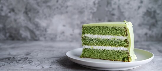 Poster - Green pandan sponge cake displayed on a white plate with copy space image.