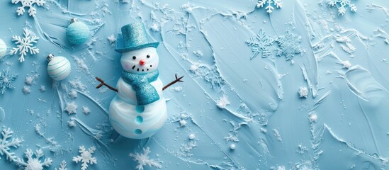 Poster - Pastel blue background with a cute metallic snowman adorned with a bell, perfect for Christmas and New Year celebrations. Top view with copy space image.