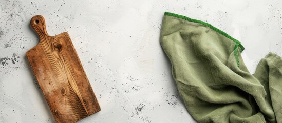 Aufkleber - A vintage rectangular cutting board with a handle is placed on a white table beside a green towel, accompanied by a blank area on the left for text or design in a copy space image.