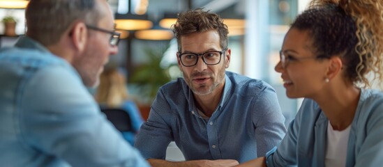 Close up of an office meeting of two men with glasses and a woman. Teamwork concept