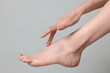 © New Africa - Closeup view of woman`s groomed foot after care procedure on grey background