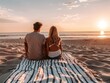 © authapol - Attractive couple watching the sunrise together from a beach blanket, with a simple background of sand and sky, dressed in comfortable beachwear, showcasing romantic and peaceful moments