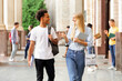 © Prostock-studio - Multiracial students walking in university campus during break and communicating, copy space