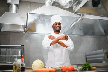 Gourmet chef in uniform cooking in a commercial kitchen.