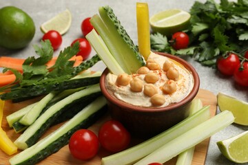Poster - Tasty homemade hummus with chickpeas served on light grey table, closeup