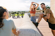 © Xavier Lorenzo - Three young fitness friends doing stretching exercise after workout routine outside. Sportive people and healthy lifestyle concept.