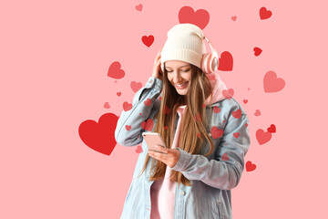 Female student with headphones and mobile phone on pink background