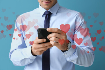 Poster - Handsome man in formal clothes using mobile phone on color background, closeup