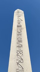 Wall Mural - Tall obelisk tower with egyptian hieroglyphs near Suleymaniye Mosque, orbital