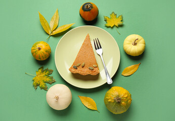 Wall Mural - Autumn composition with tasty pumpkin pie on green background