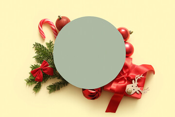 Wall Mural - Green round blank card with red Christmas decor on light yellow background