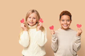 Poster - Cute little children with red paper hearts on brown background. Valentine's day celebration