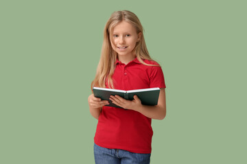 Poster - Cute little girl with book on green background