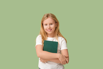 Poster - Cute little girl with book on green background