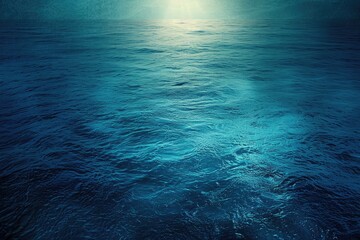 The image is of a calm ocean with a blue sky in the background. The water is still and the sky is clear, creating a peaceful and serene atmosphere