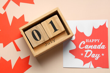 Wall Mural - Greeting card, Maple leaves and calendar on beige background. Canada Day concept