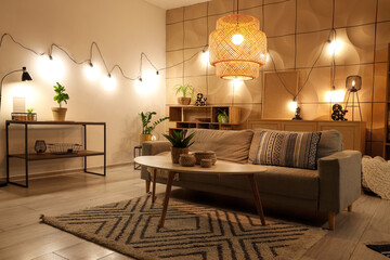 interior of living room with sofa, coffee table and glowing lamps