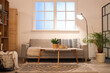 © Pixel-Shot - Interior of stylish living room with comfortable sofa, coffee table and glowing lamps