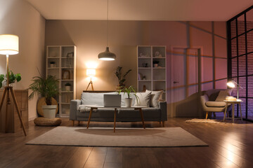 Poster - Interior of living room with sofa, armchair, table and glowing lamps