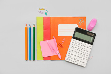 Wall Mural - Calculator and different stationery on grey background