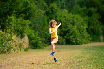 Canvas Print - Morning running jogging with children. Child runner jogger running in the nature. Active healthy kids lifestyle. Sporty kid running in street. Sporty child boy runner running in park.