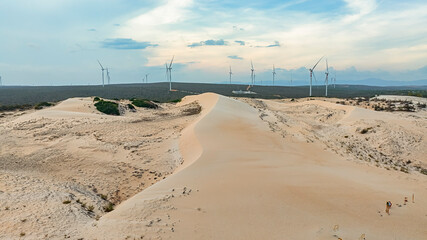 Wall Mural - windmill park with clouds and a blue sky, wind mill turbines in the ocean aerial view of a wind farm