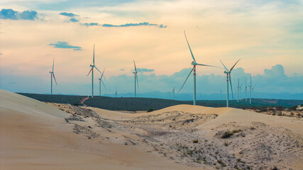 Wall Mural - windmill park with clouds and a blue sky, wind mill turbines in the ocean aerial view of a wind farm