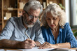 © NE97 - Portrait of a married couple making a will in a business office, estate planning, close-up.