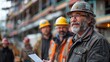 © bird_saranyoo - A geotechnical engineer is talking with a construction supervisor at the site of a new building. Engineer holding a clipboard