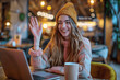 © btiger - Happy joyful woman communicating in sign language online using laptop in cafe, smiling girl having video call with friends in coffee shop, evening lifestyle