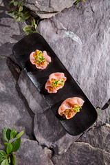 Sticker - Salmon Tartare on Rice Chips - Gourmet Culinary Presentation on Slate Background