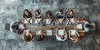 © Vertigo Images - Top view of group of multiethnic busy people working in an office, Aerial view with businessman and businesswoman sitting around a conference table with blank copy space, Business meeting concept