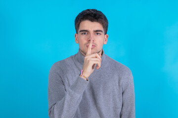 Poster - isolated young man with silence gesture