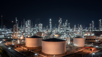 Wall Mural - Aerial view oil and gas refinery at night, Business petrochemical industry refinery oil and gas factory power and fuel energy, Oil and gas storage tank fuel refinery industry at night.