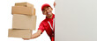 © Jamaludinyusup - Excited Asian delivery man or courier peeks out from behind a white wall with copy space, holding a cardboard box, isolated on a white background. Delivery services, shipping, or e-commerce businesses