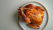 © reddish - A close-up overhead shot of a roasted turkey on a white plate with a white background. The turkey is fully cooked and has a golden brown crust