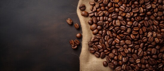 Fototapete - On a white table background, there is a top-down view of roasted coffee beans next to a sack, with room for additional content in the image.