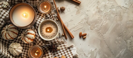 Aufkleber - Top-down view of an autumn-themed composition featuring a cocoa mug, candles, nuts, and cinnamon on a beige plaid surface for a copy space image.
