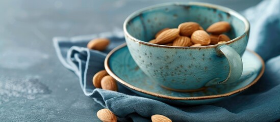 Aufkleber - Copy space image of an almond in a ceramic cup set on a blue napkin.