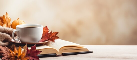 Poster - Autumn-themed decorations with a cup of delicious coffee, beside an empty book, set against a light background with copy space image.